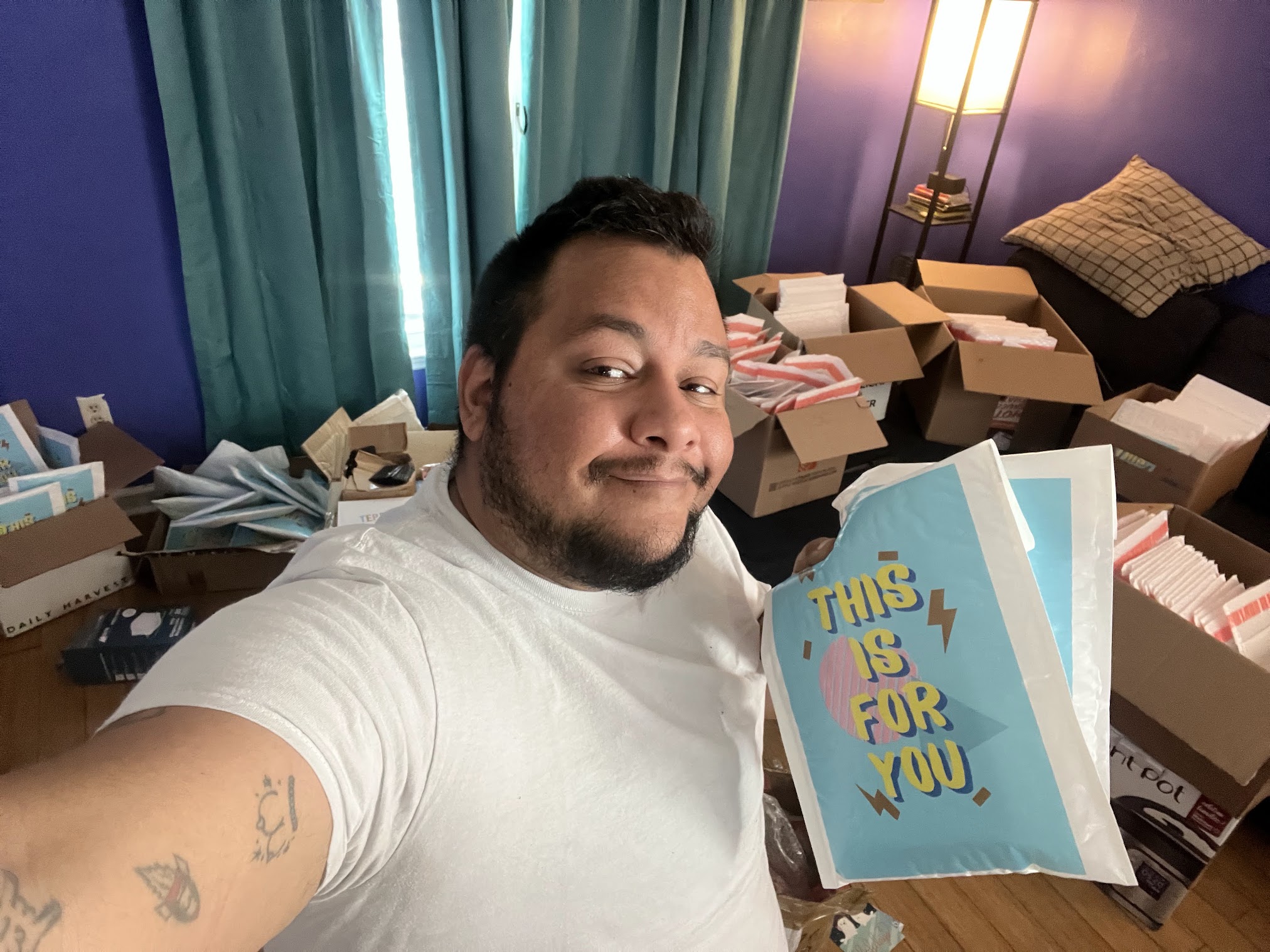 Founder Jack Knoxville is shown wearing a white Tshirt and smiling in a selfie while  taking a break from packaging safety kits for the community.