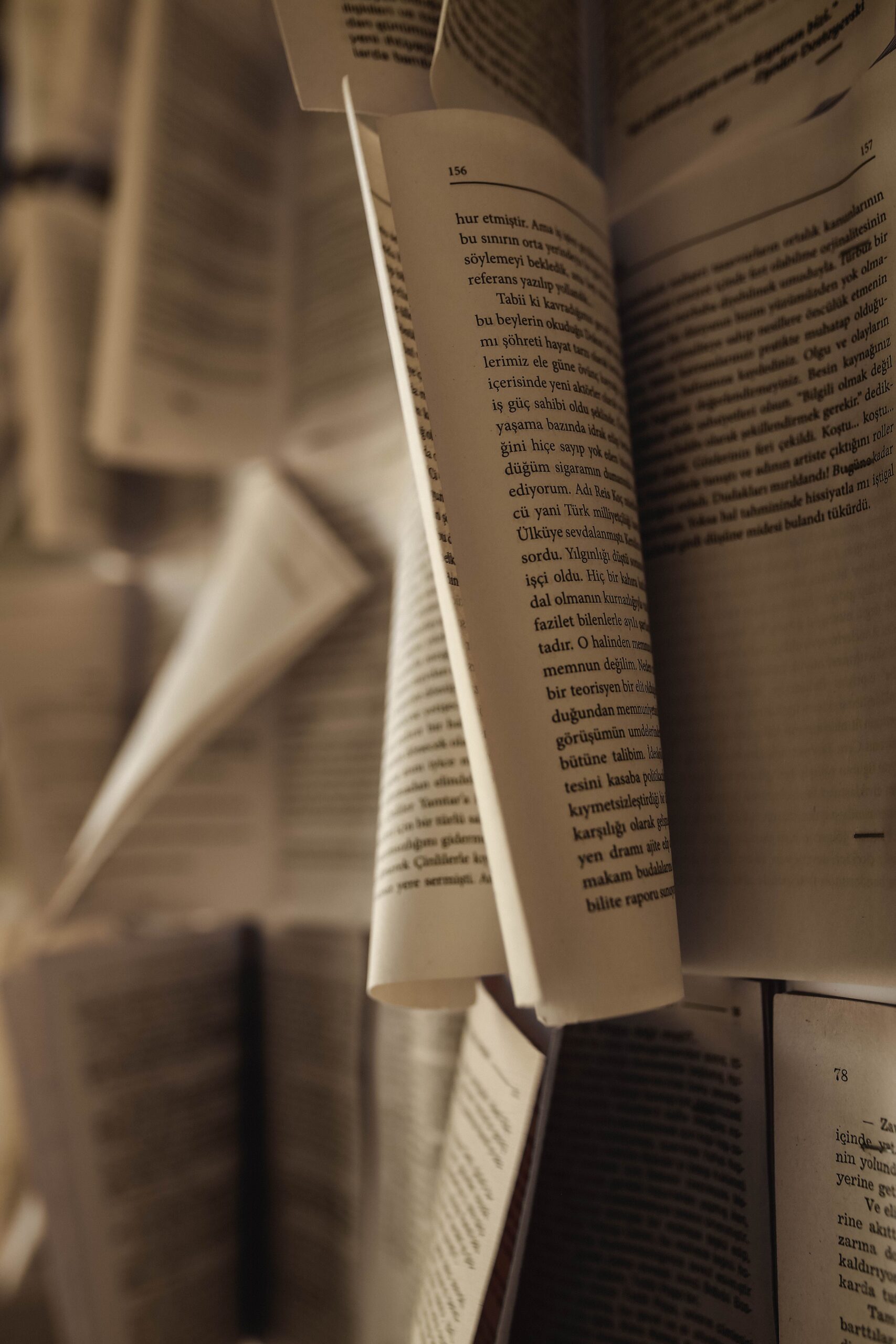 random book pages with text are seen strewn about